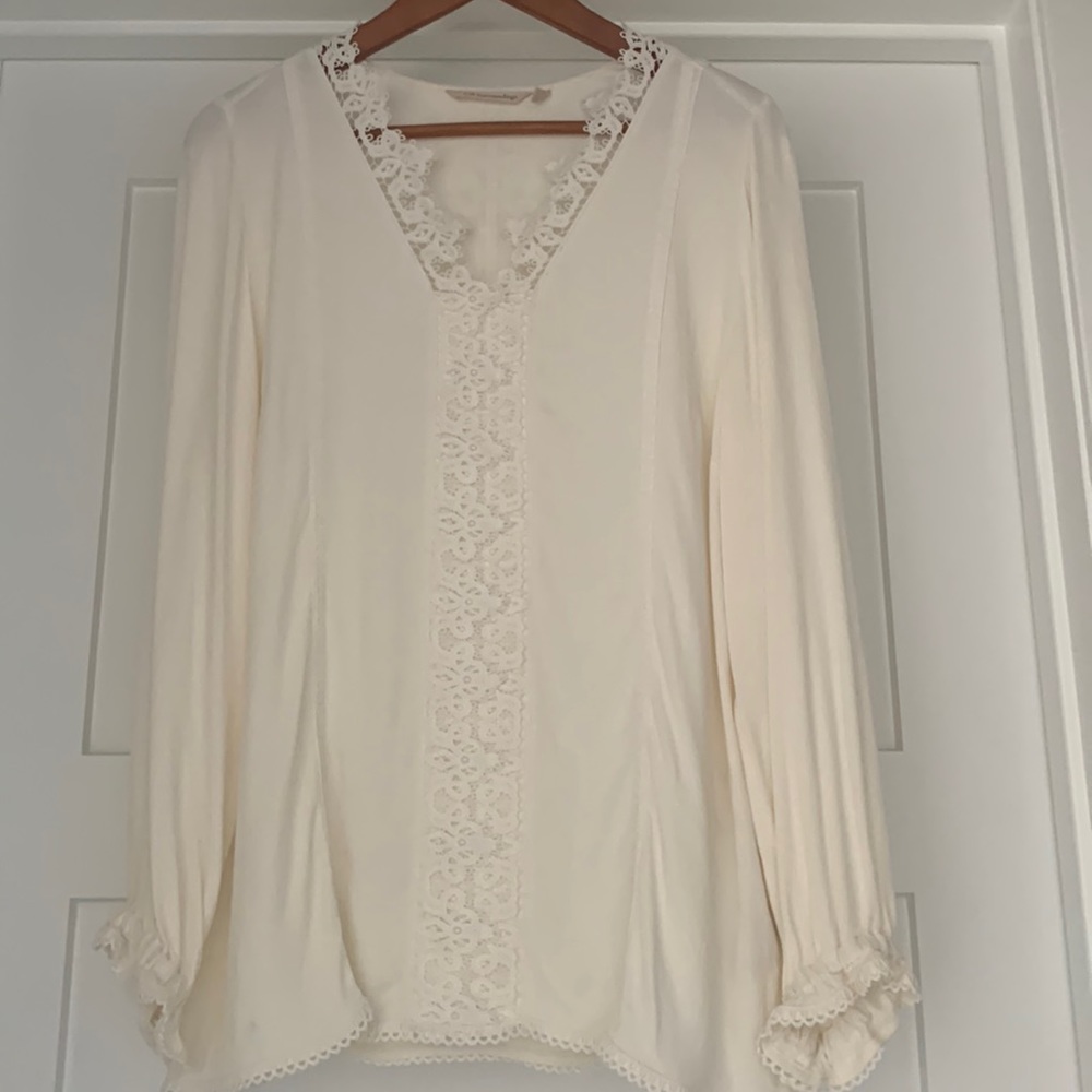 Long sleeved top with lace neckline and lace down center of back.